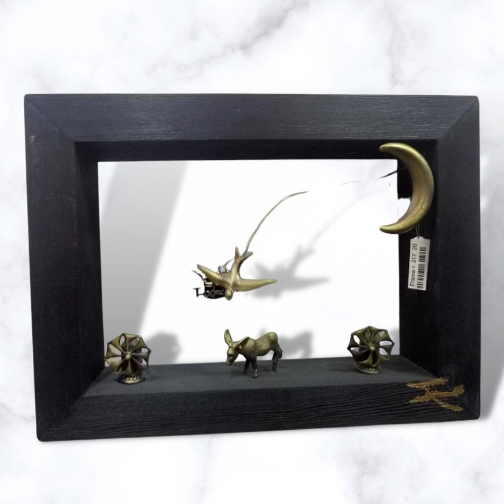 Bronze sculpture in frame 